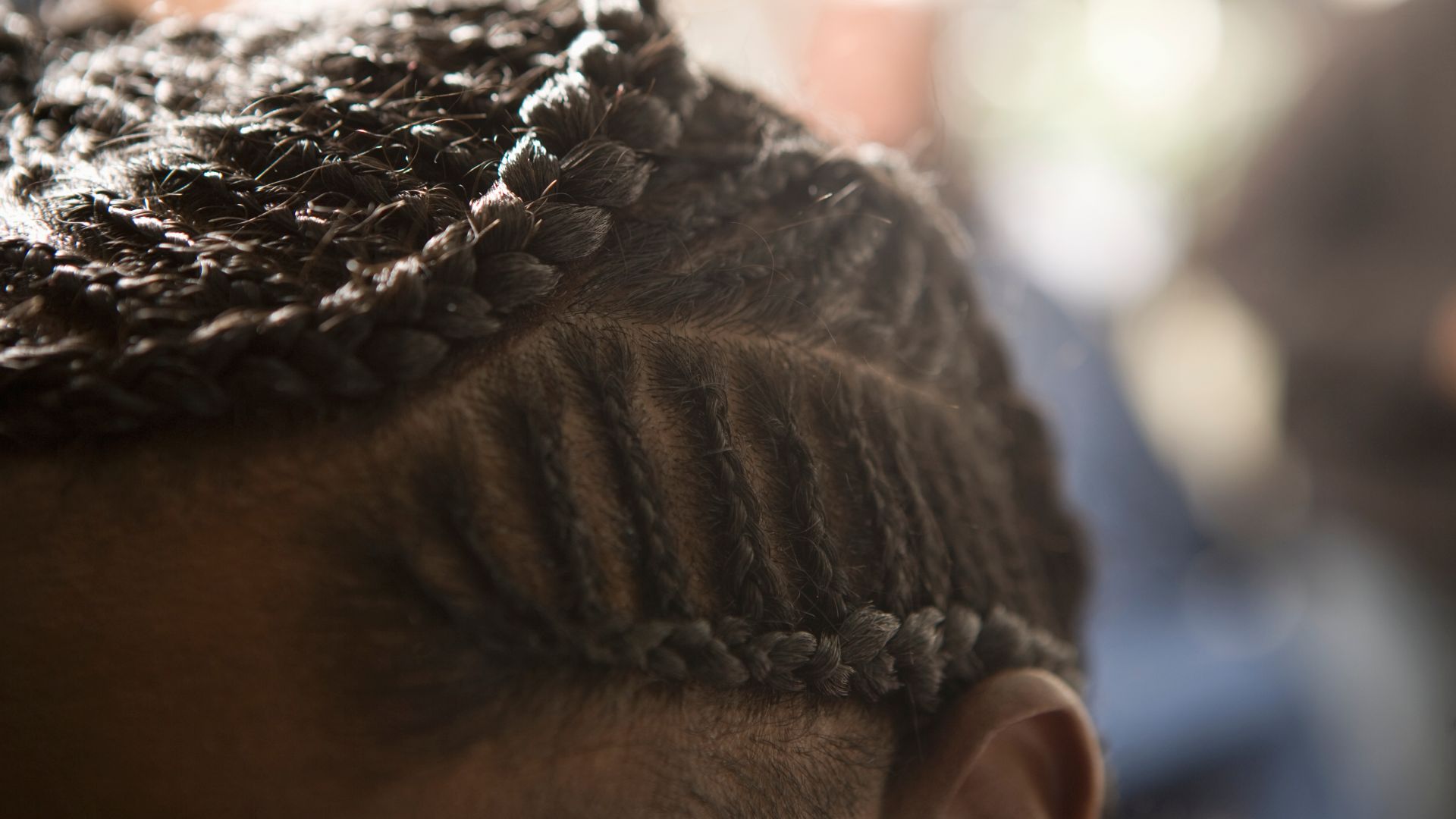 Detailed close-up of intricate braided hair with tight cornrows